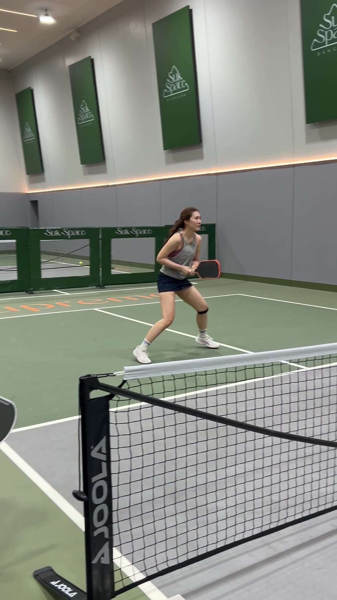 Doubles play on indoor courts